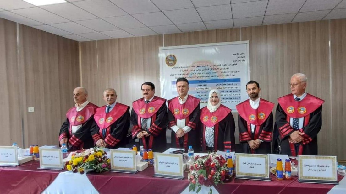 “A lecturer from the College of Education for Humanities participates in discussing his doctoral thesis at Saladin University.”