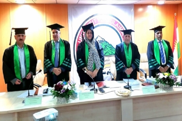 A faculty member from the University of Kirkuk participates in the discussion of a master's thesis at the University of Sulaymaniyah.