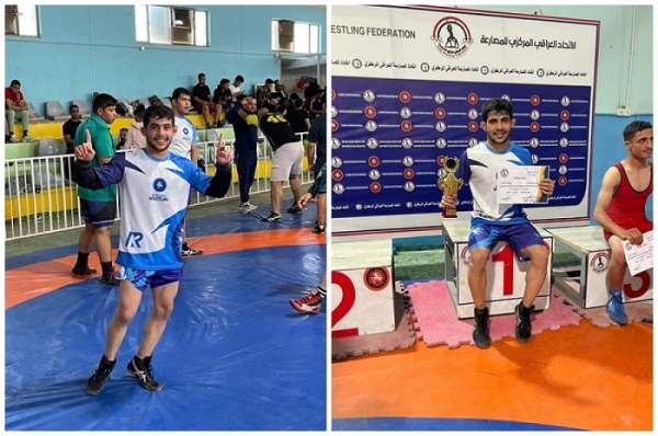 A student from the University of Kirkuk holds the Iraqi Wrestling Championship Cup