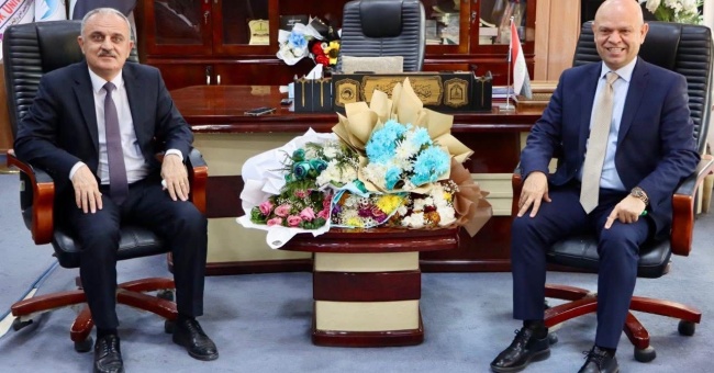 The Dean of the College of Physical Education and Sports Sciences and a number of faculty members congratulate the Assistant President of Kirkuk University for Administrative Affairs on assuming his position.