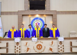 A faculty member from the College of Physical Education and Sports Sciences participates in a master's thesis defense committee at Tikrit University.
